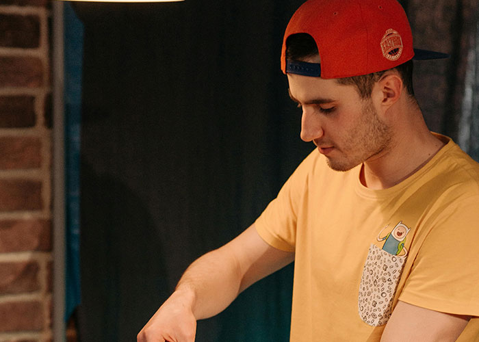 Young man in a red cap and yellow shirt looking down, illustrating stories about why people called off their engagements.