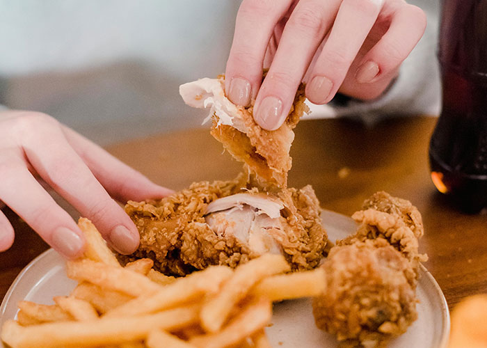 Buffet workers encounter wild moments as someone picks fried chicken and fries from a plate during a meal.