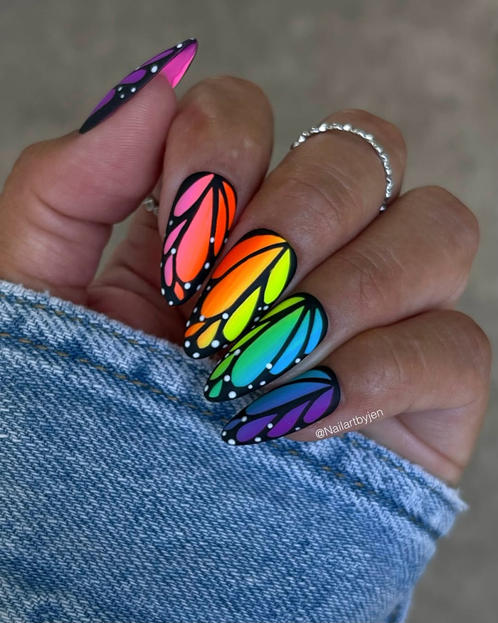 Bright rainbow butterfly wing nail art on long nails, showcasing trendy summer nails design and vibrant colors.