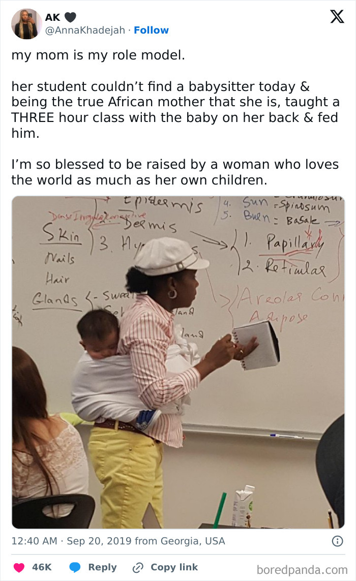 African mother teaching a class with a baby on her back, demonstrating love and dedication in a wholesome feel-good moment.