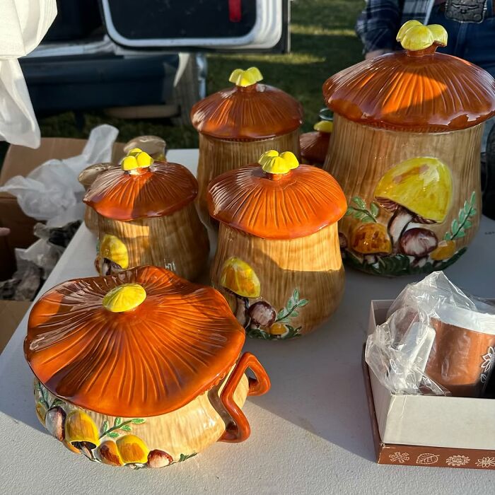 Ceramic mushroom-shaped containers displayed as cool secondhand finds at an outdoor market or sale.