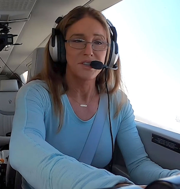 Person wearing headset and glasses piloting an aircraft, related to famous people who did evil things in the past.