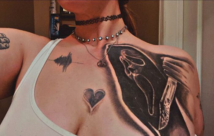 Tattoo of a heart, soundwave, and a distorted figure on a woman's shoulder showcasing hilariously bad tattoos and inkshaming.