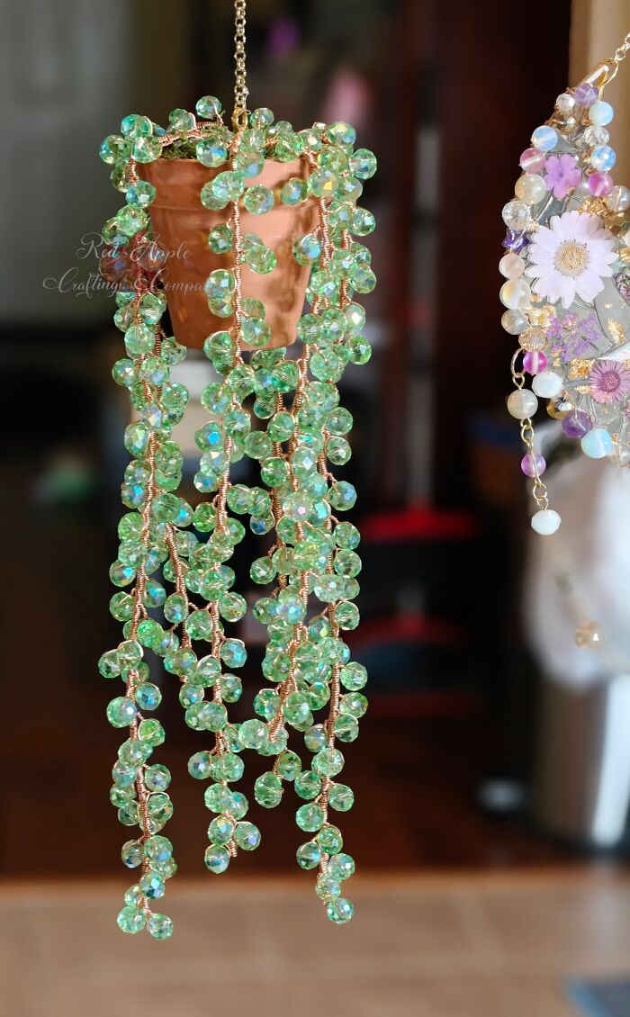 Hanging DIY craft project made with green beads and copper wire, showcasing a homemade decorative craft shaming example.