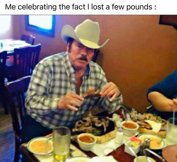 Man in cowboy hat celebrating weight loss while eating a large meal, a funny post for sharing with friends.