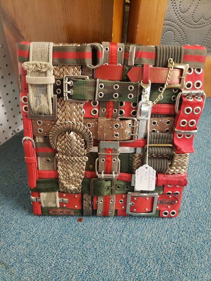 Patchwork bag made from various old belts with mixed colors and textures, showcasing a unique but questionable craft.