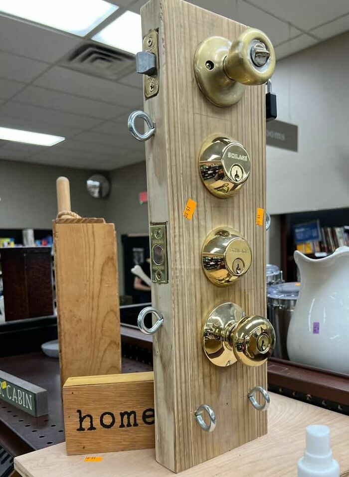 DIY project fail showing a wooden board with multiple mismatched door knobs and locks in a thrift store setting.