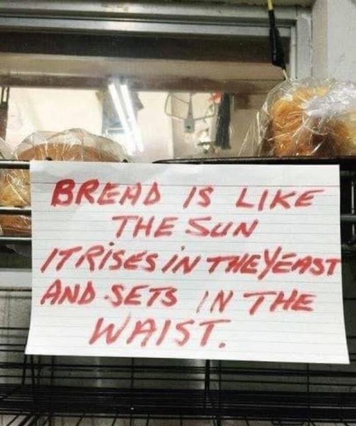Humorous handwritten sign comparing bread to the sun, adding chaos with a funny twist on yeast and waist.