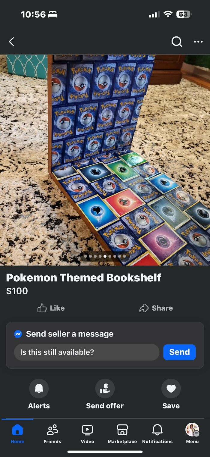 DIY project featuring a Pokemon themed bookshelf decorated with multiple Pokemon cards on a carpeted floor