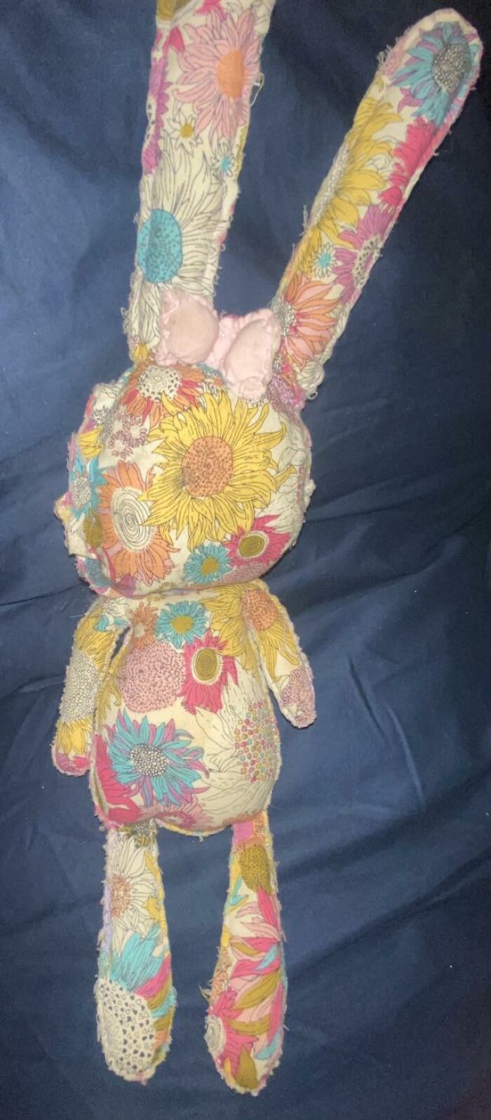 Handmade stuffed bunny with floral fabric showing uneven stitching and visible imperfections in craft shaming DIY project.