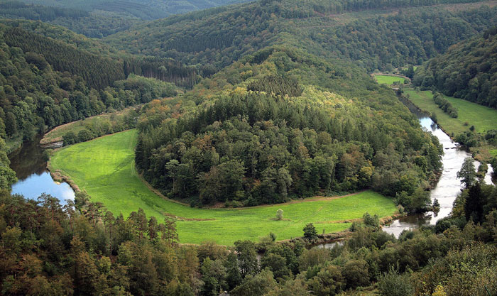 Aerial view of green forest and river landscape, one of the scariest places around the world for brave travelers.