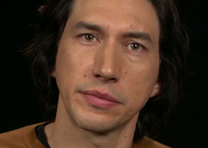 Close-up of a man with dark hair against a black background, illustrating what celebrities were doing before fame.