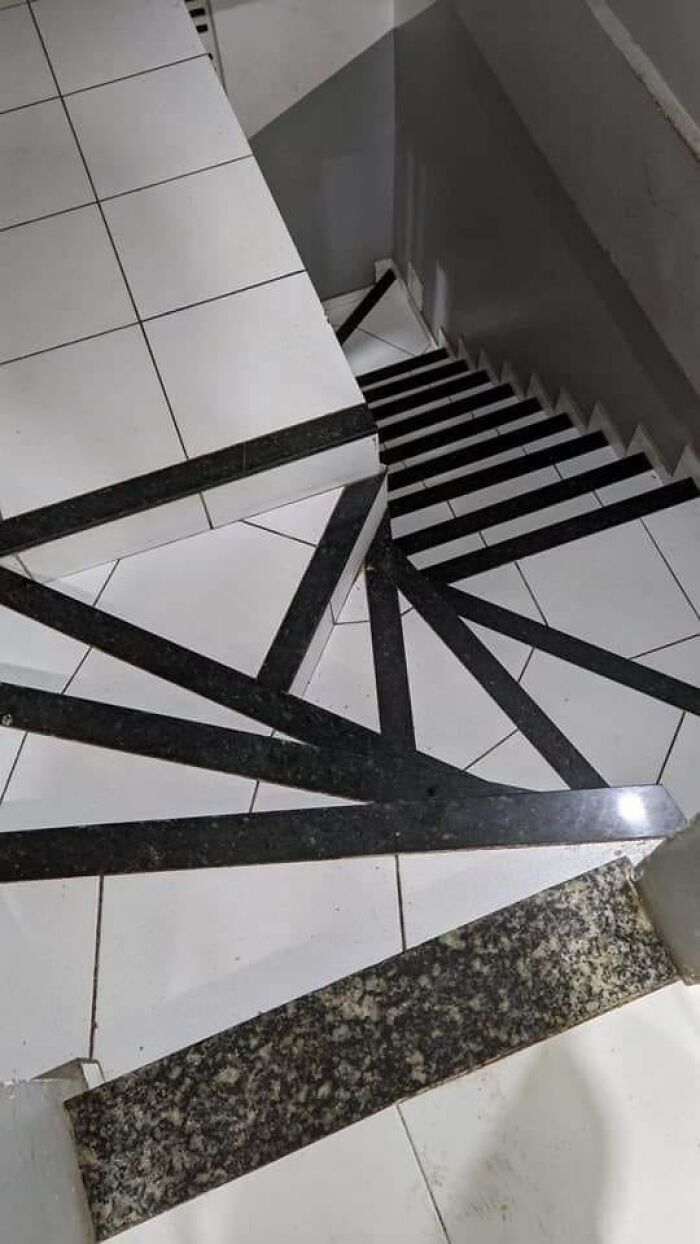 Steep death stairs with confusing black and white tile patterns creating a dangerous and disorienting visual effect.