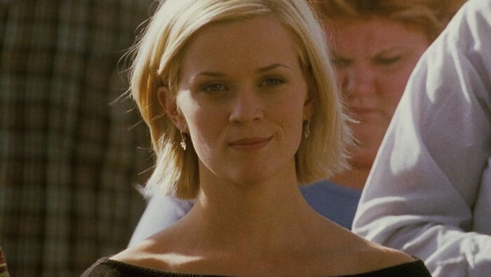 Close-up of a woman with short blonde hair from a romantic movie scene discussing toxic relationships in romantic films.