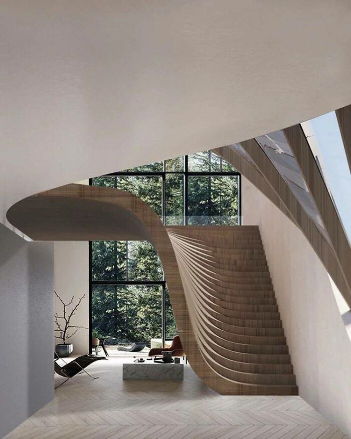 Modern interior with elegant curved wooden death stairs and large windows showing a green forest outside.