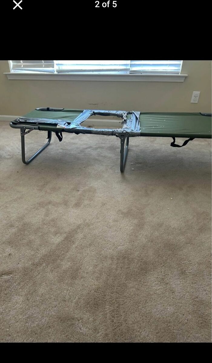 Worn-out DIY craft project shows a green cot with a torn middle section patched badly with duct tape indoors.