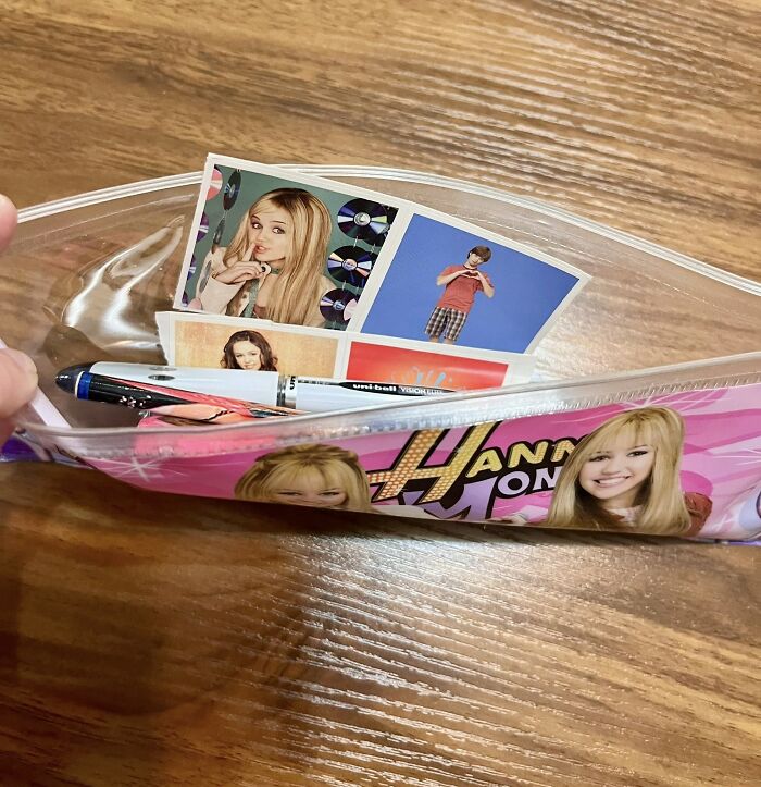 Clear pencil case with old school photo cards and pen, connecting nostalgia with people not fully relating to Millennials or Gen Z