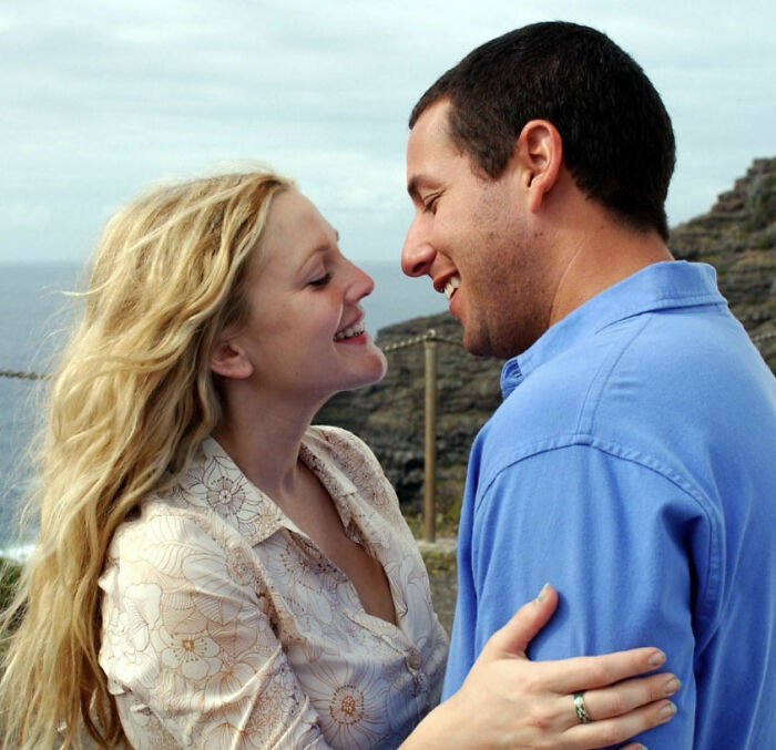 Romantic couple smiling and embracing outdoors, illustrating movies that are considered romantic but toxic instead.