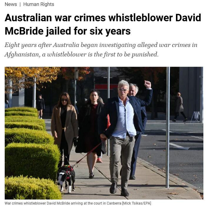 Man walking a dog on a city sidewalk with people behind him, representing traumatizing the next generation concept.