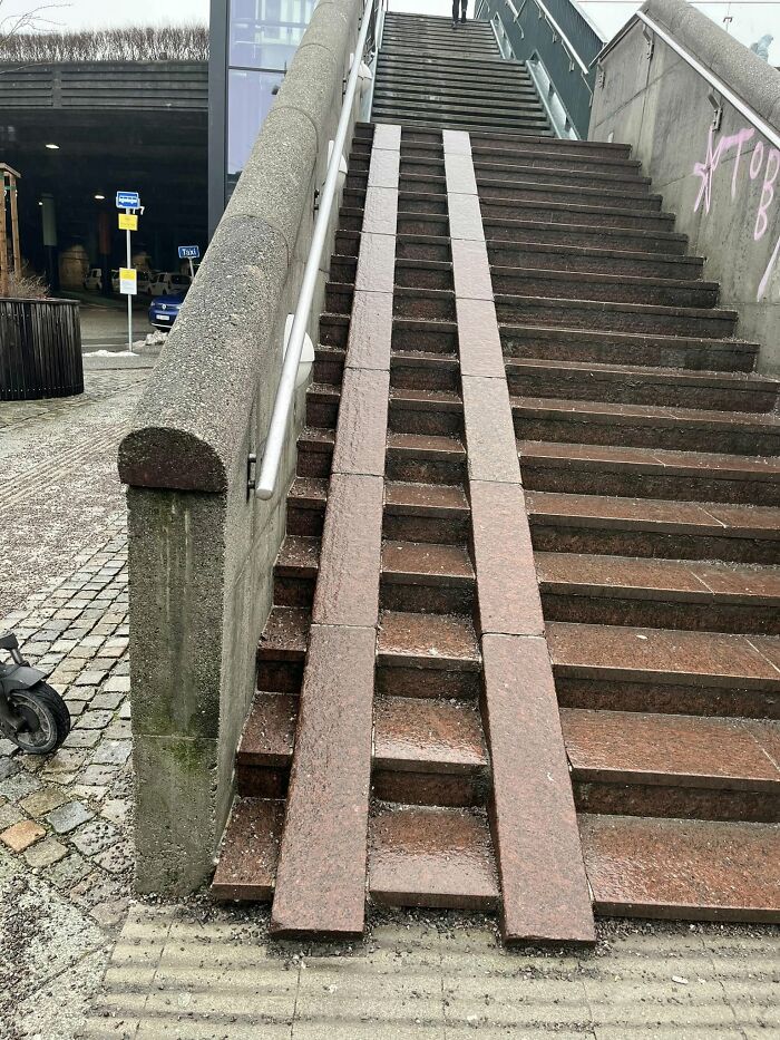 Uneven and impractical death stairs with narrow ramps that make taking the stairs a dangerous and difficult option.