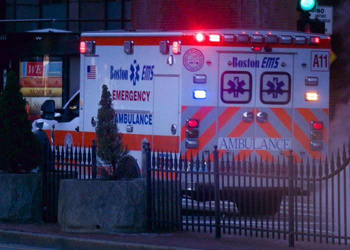 Boston EMS emergency ambulance with flashing lights responding, illustrating wildest encounters shared by buffet workers.