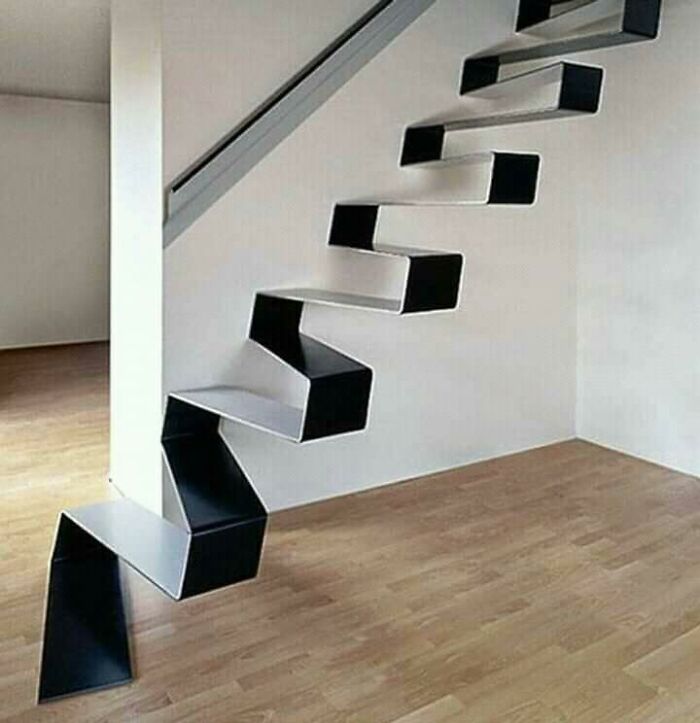 Modern death stairs with sharp angles and black and white design creating a risky and dangerous staircase in a minimalist room.