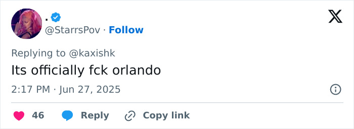 Screenshot of a social media reply expressing anger towards Orlando Bloom following Katy Perry breakup news.