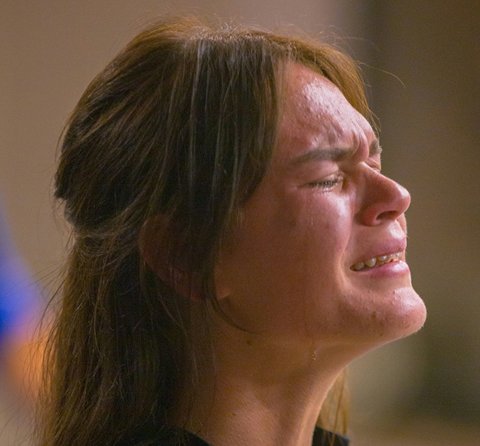 Woman crying in emotional distress, representing conflict with in-laws over cutting contact during family tragedy.