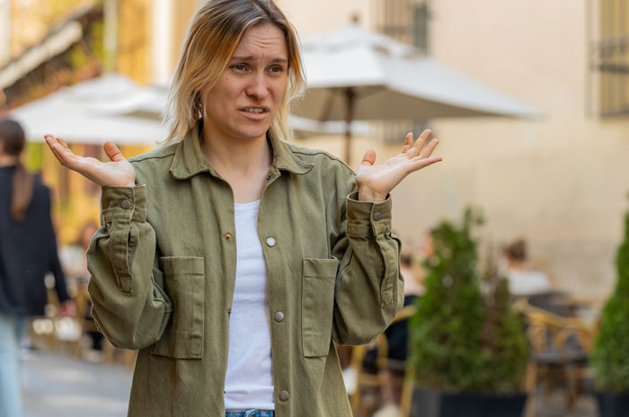 Frustrated parent throwing a tantrum outdoors after being denied letting their kids ride a dog in a public area.