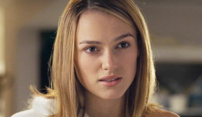 Close-up of a woman with blonde hair expressing concern in a scene from a romantic but toxic movie.