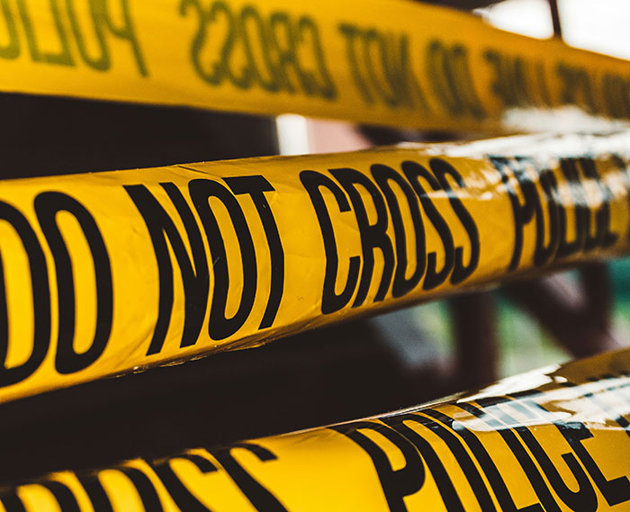 Yellow police do not cross tape marking a crime scene related to a viral story about marriage challenges and shooting incident.