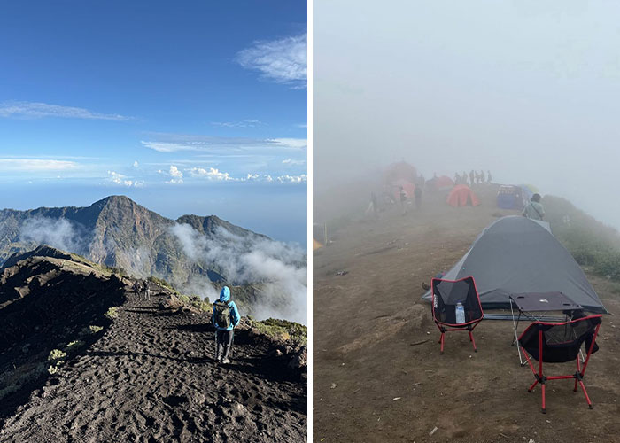 Hiker trekking on Indonesian volcano trail amid clouds and misty campsite with tents and chairs on foggy terrain.