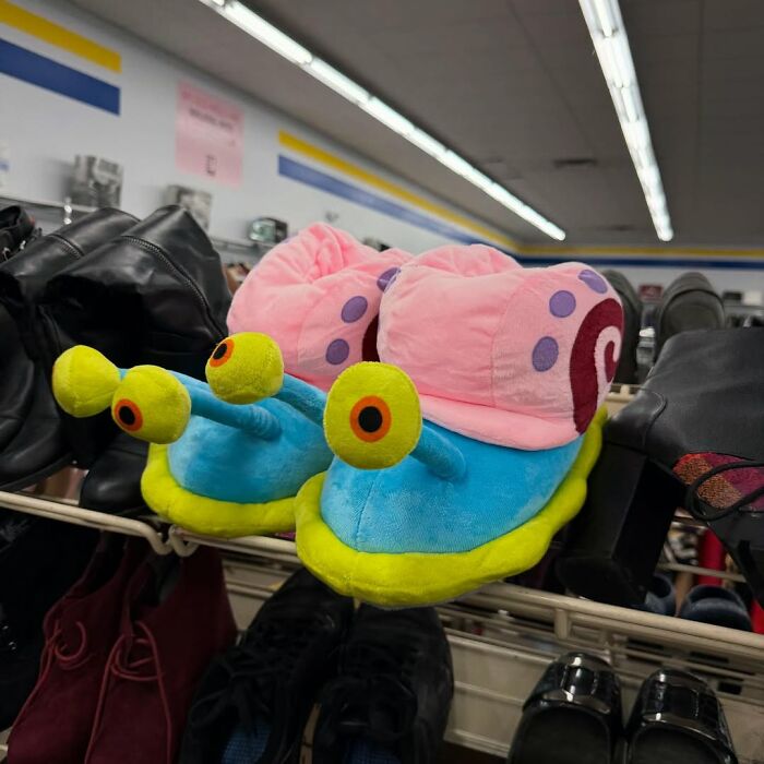 Plush snail slippers on display among shoes in a thrift store showcasing cool secondhand finds for bargain shoppers.