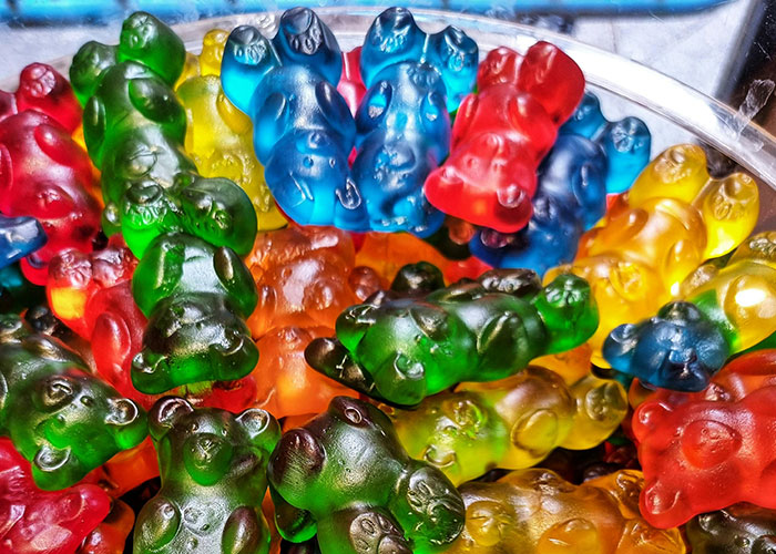 Colorful gummy bears piled in a candy display, illustrating fun and wild encounters shared by buffet workers.