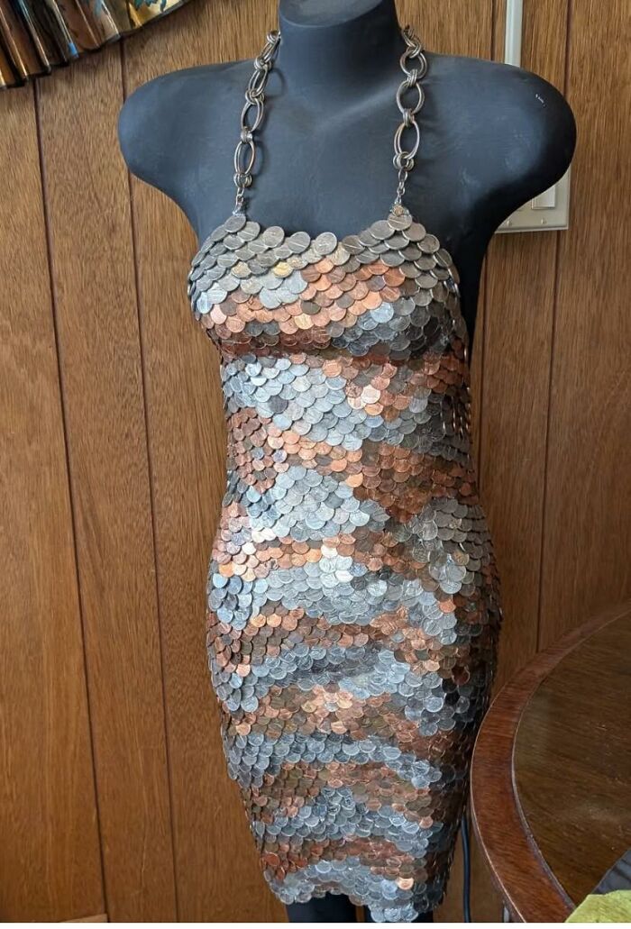DIY project dress made entirely of glued coins displayed on a mannequin as a craft shaming example
