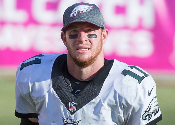 Philadelphia Eagles player wearing jersey and cap on the field, representing a take one for the team moment in sports.