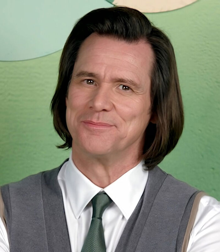 Close-up of a man with shoulder-length hair wearing a white shirt, green tie, and gray vest, representing famous people.