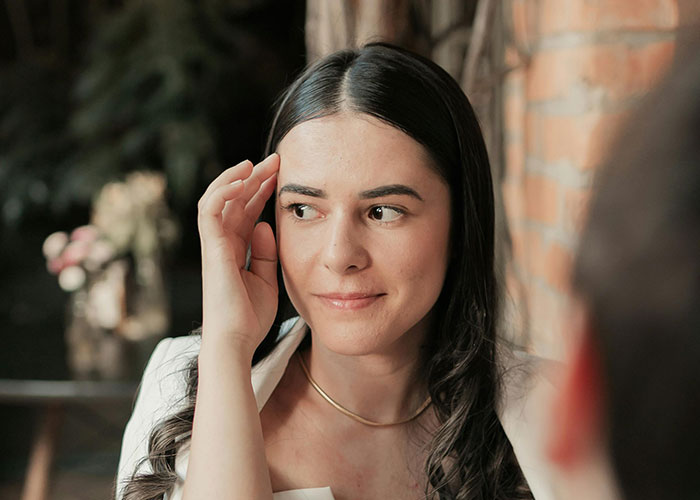 Young woman looking awkward and uncomfortable during a painful and awkward date in a cozy restaurant setting