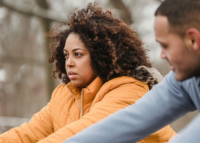 Couple having a tense conversation outdoors, illustrating emotional moments in called off engagements and relationship struggles.