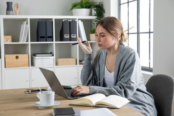 Woman working on laptop in home office, illustrating professions that attract the most awful people and finance bros. - 31