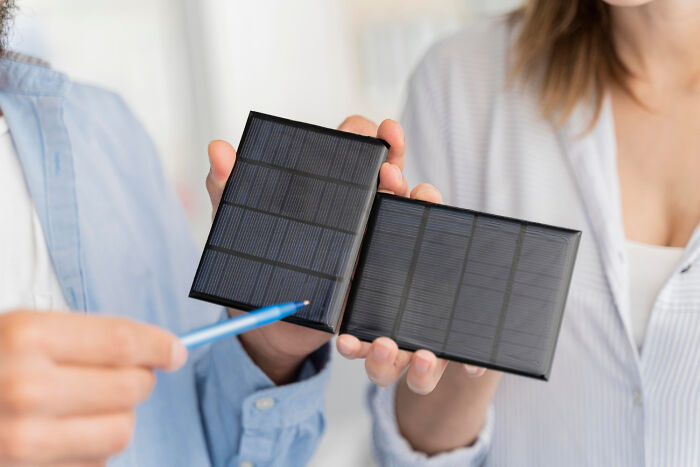 Two people holding solar panels, illustrating unexpected items causing problems for airport security checks.