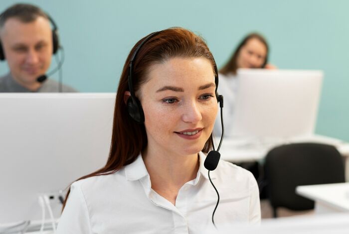 Customer support team wearing headsets, engaged in calls as a good trend slowly disappeared in office environment.