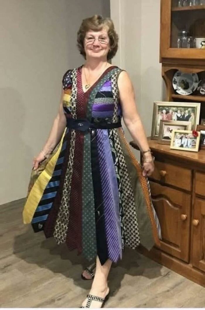 Woman wearing a colorful DIY dress made of repurposed ties, showcasing a craft shaming example of horrendous DIY projects.
