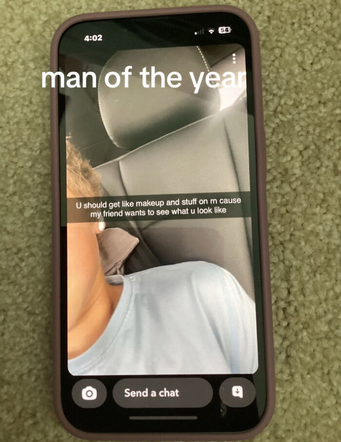 Screenshot on a phone showing a message suggesting makeup, related to men of the year nominations.