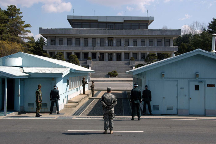 Military personnel standing guard at a tense border checkpoint, one of the scariest places around the world.
