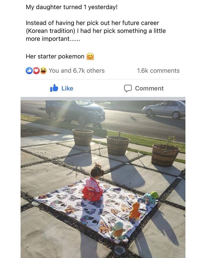 Toddler sitting on a blanket with starter Pokémon toys outside, a wholesome moment to restore faith in humanity.