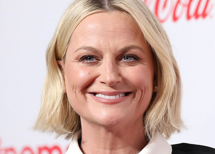 Smiling blonde woman at an event, representing what celebrities were doing before fame found them.
