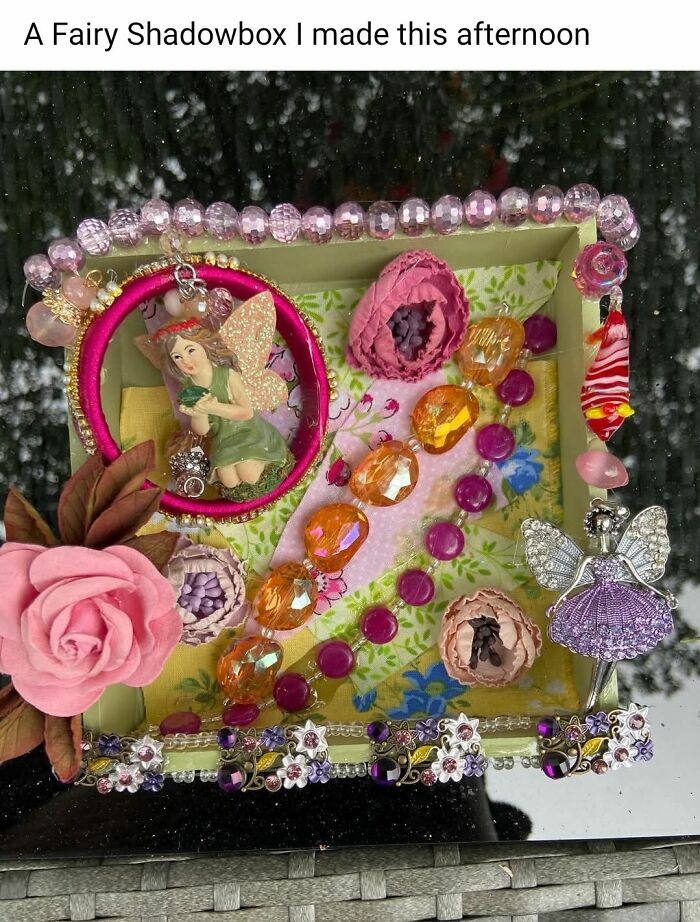 Handmade fairy shadowbox craft with beads, flowers, and decorative charms in a colorful, mixed-media arrangement.
