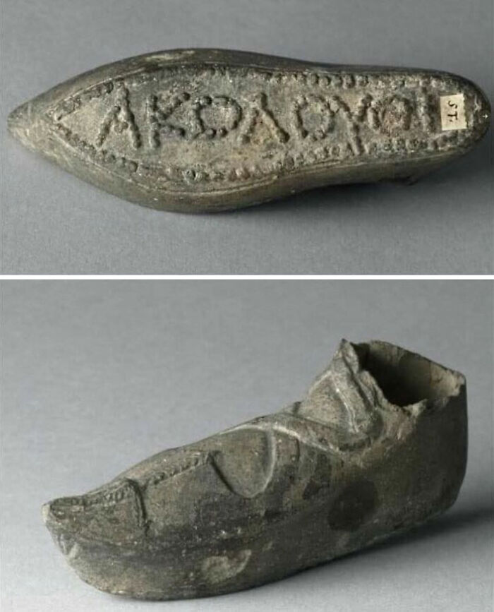 Ancient lead artifact shaped like a shoe with Greek inscriptions showcasing archaeology world historical significance.