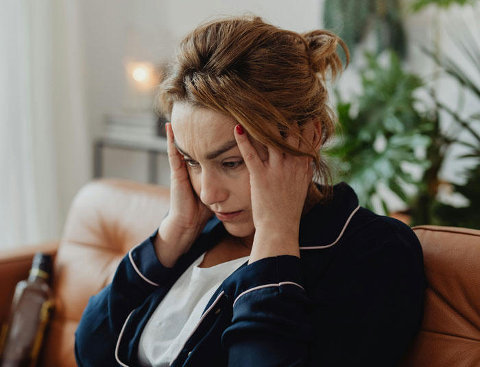 Freelancer stressed and frustrated at home, reacting to entitled church member demanding free work due to working from home.
